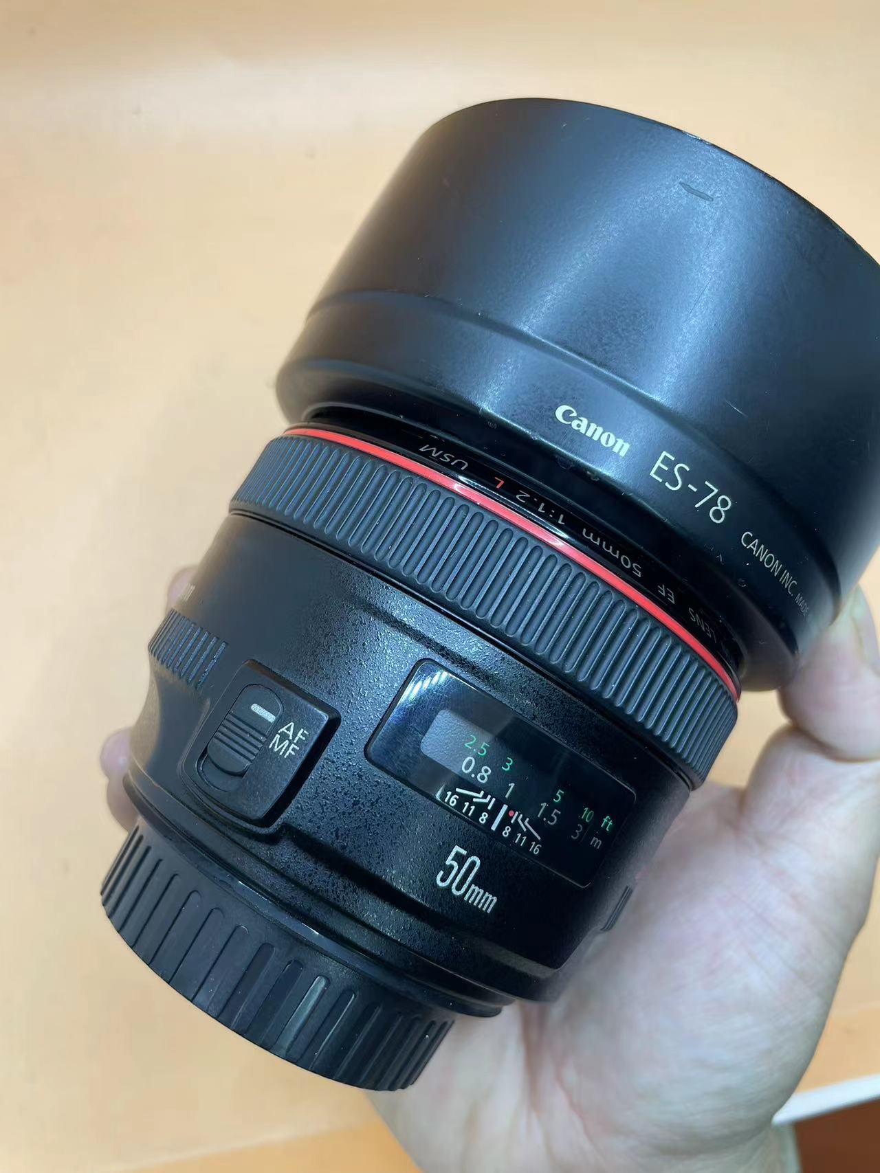 佳能50-1.8二代值得买吗,佳能50-1.2全新的多少钱